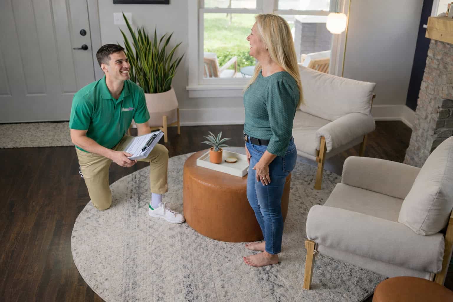 Technician cleaning a patterned area rug in a living room in Aurora, IL