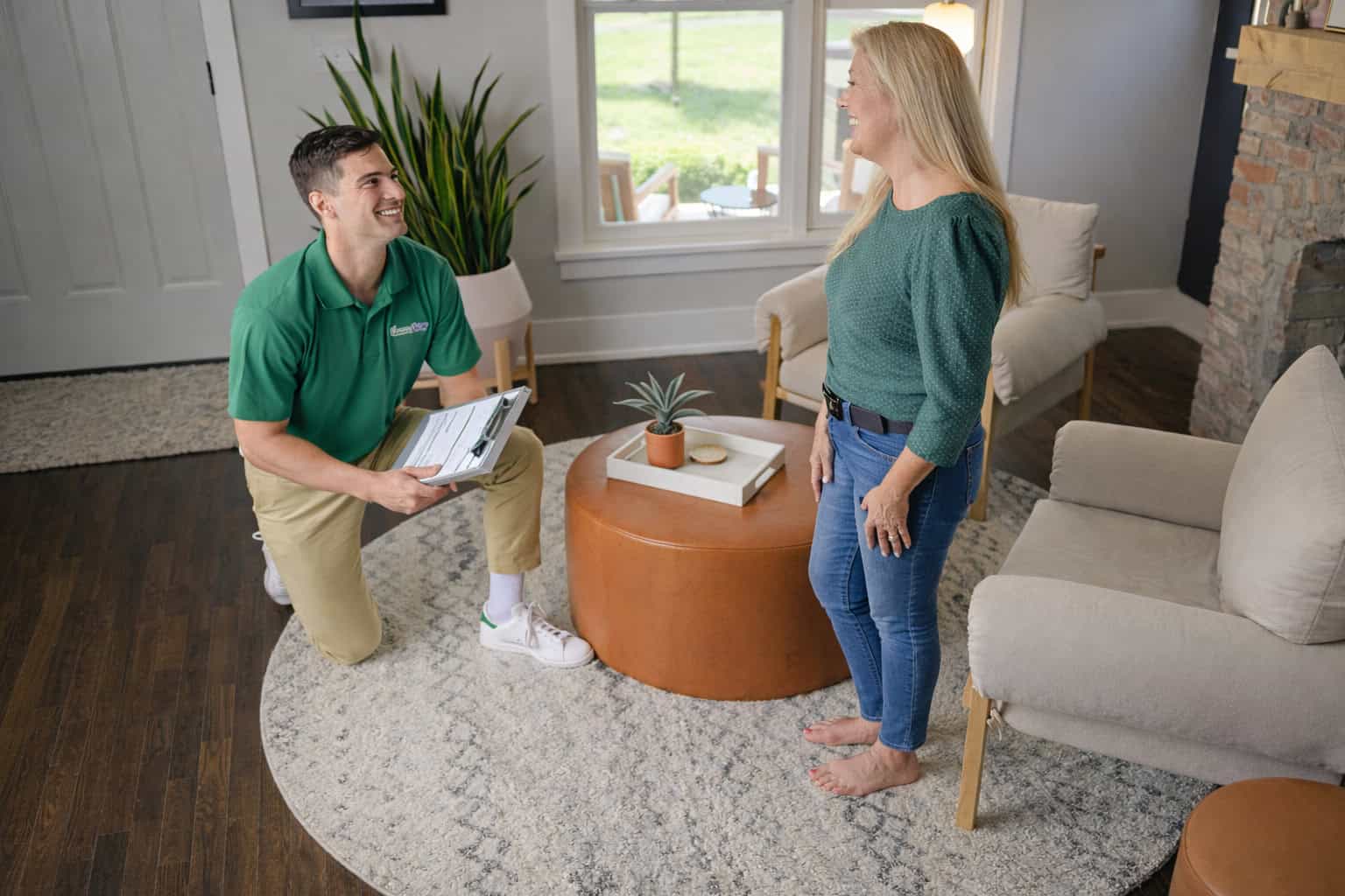 Technician cleaning an area rug inside a home in Carpentersville, IL