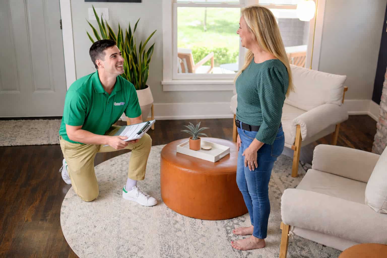 Technician cleaning a large area rug in a living room in Palatine, IL